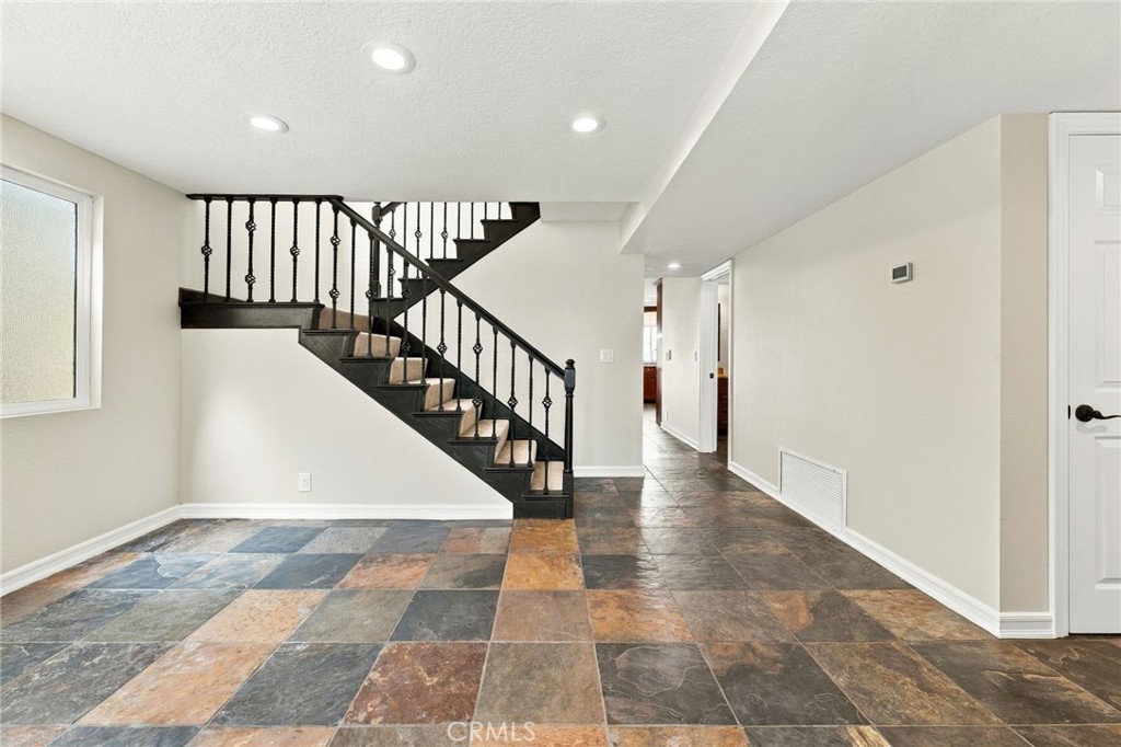 Refreshed dining area with new frosted glass window is positioned beside the staircase and features recessed lighting an - 803 Frankfort Avenue, Huntington Beach CA 92648 - photo 15