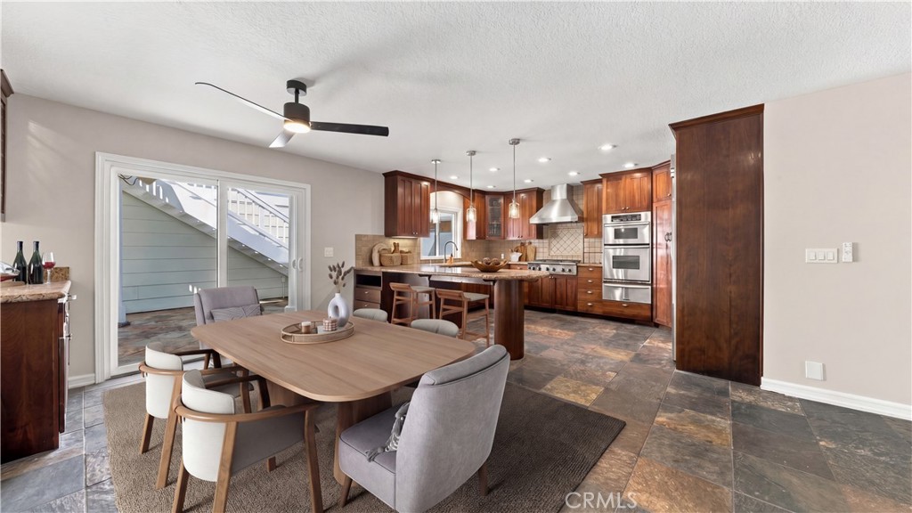 Dining space flows directly into the kitchen for easy everyday living and entertaining. Photo has been virtually staged. - 803 Frankfort Avenue, Huntington Beach CA 92648 - photo 16