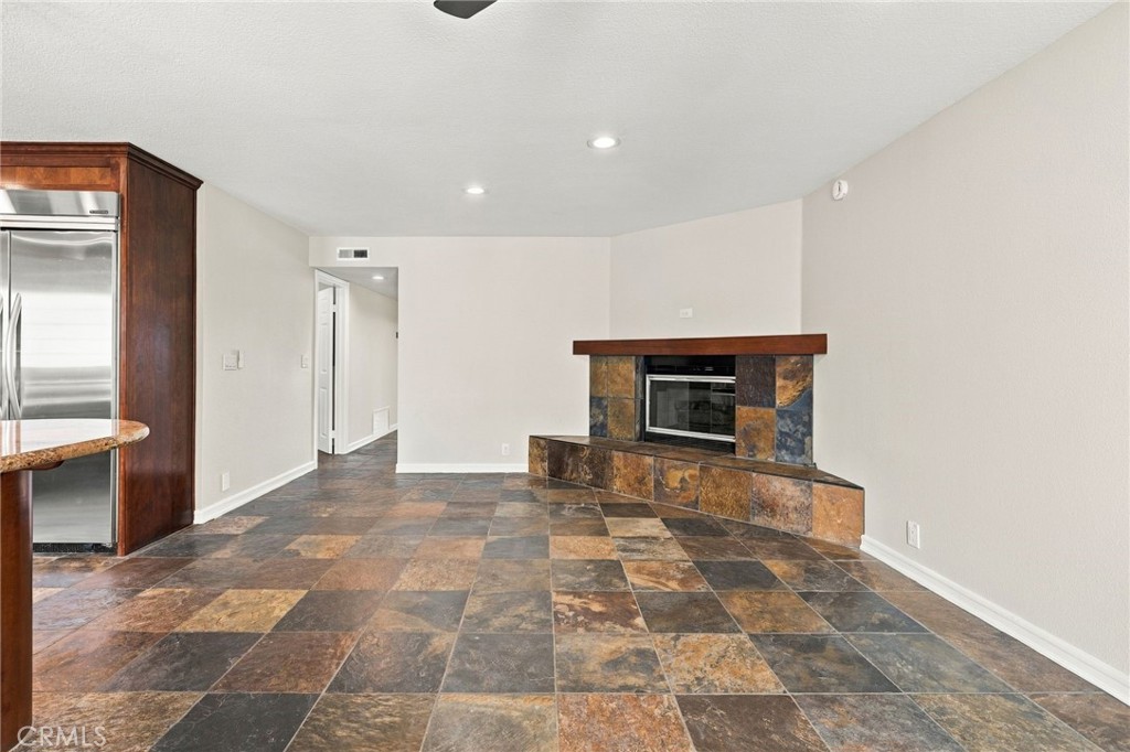 Family room offers a separate gathering space centered around a fireplace with raised hearth and mantel. - 803 Frankfort Avenue, Huntington Beach CA 92648 - photo 21