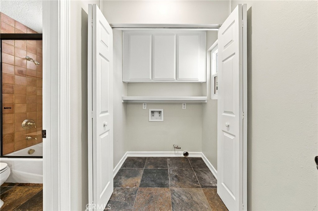Dedicated downstairs laundry room adds convenience and additional storage. - 803 Frankfort Avenue, Huntington Beach CA 92648 - photo 28