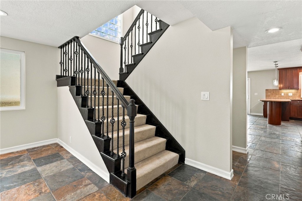 Updated staircase leads to all three upstairs bedrooms and the home's upper outdoor spaces. - 803 Frankfort Avenue, Huntington Beach CA 92648 - photo 29