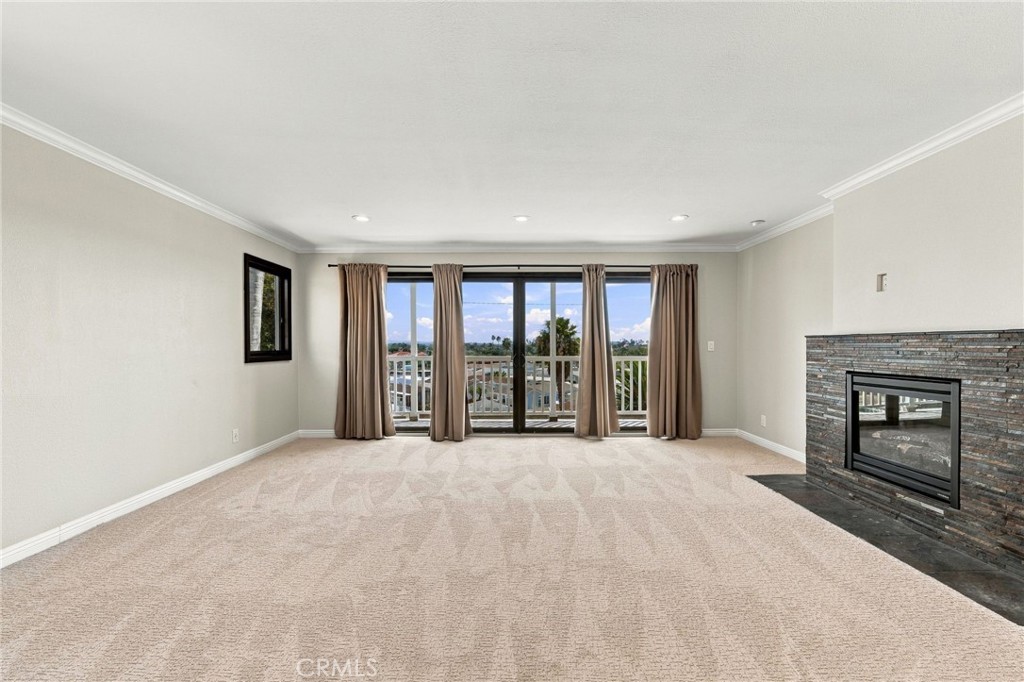 Spacious primary bedroom features new carpet, crown molding, recessed lighting, and French sliders to the balcony. - 803 Frankfort Avenue, Huntington Beach CA 92648 - photo 32