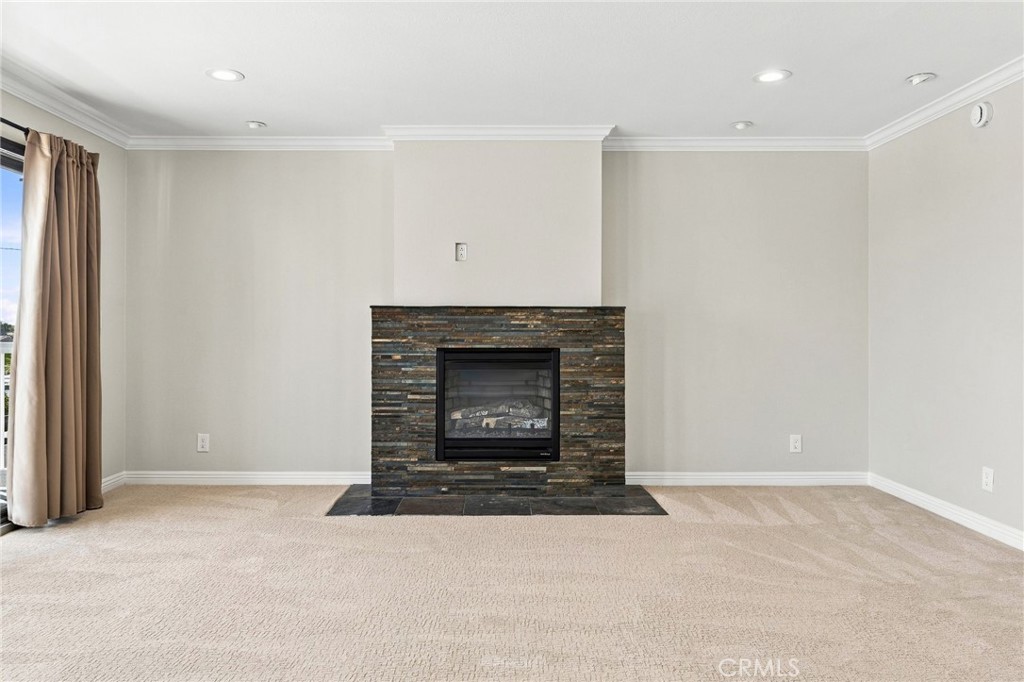 A private fireplace creates a distinctive focal point within the primary bedroom. - 803 Frankfort Avenue, Huntington Beach CA 92648 - photo 34