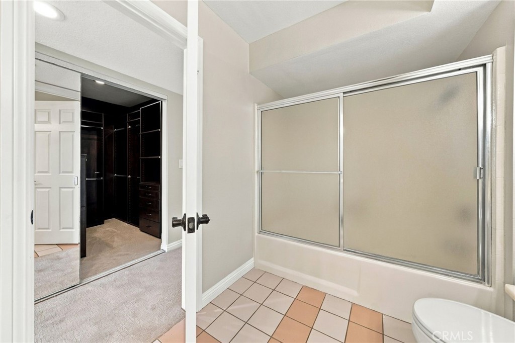 Primary bathroom includes a tub/shower combination with glass enclosure. - 803 Frankfort Avenue, Huntington Beach CA 92648 - photo 37