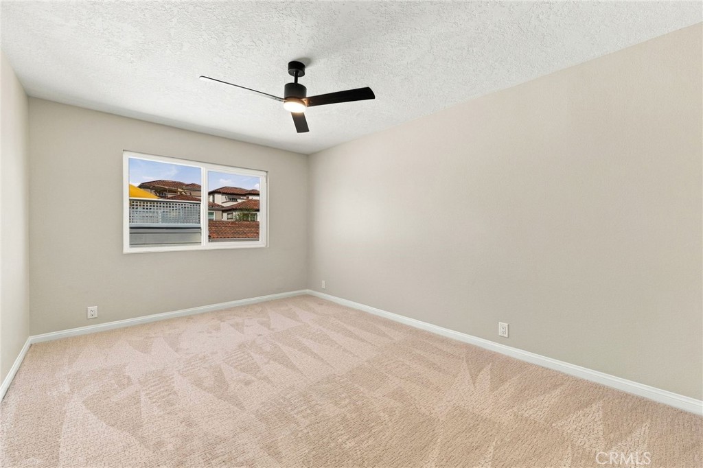 Secondary bedroom features new carpet, ceiling fan, and natural light. - 803 Frankfort Avenue, Huntington Beach CA 92648 - photo 43