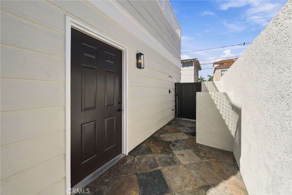 Exterior access leads to the detached 2-car garage and additional rear parking area. - 803 Frankfort Avenue, Huntington Beach CA 92648 - photo 62