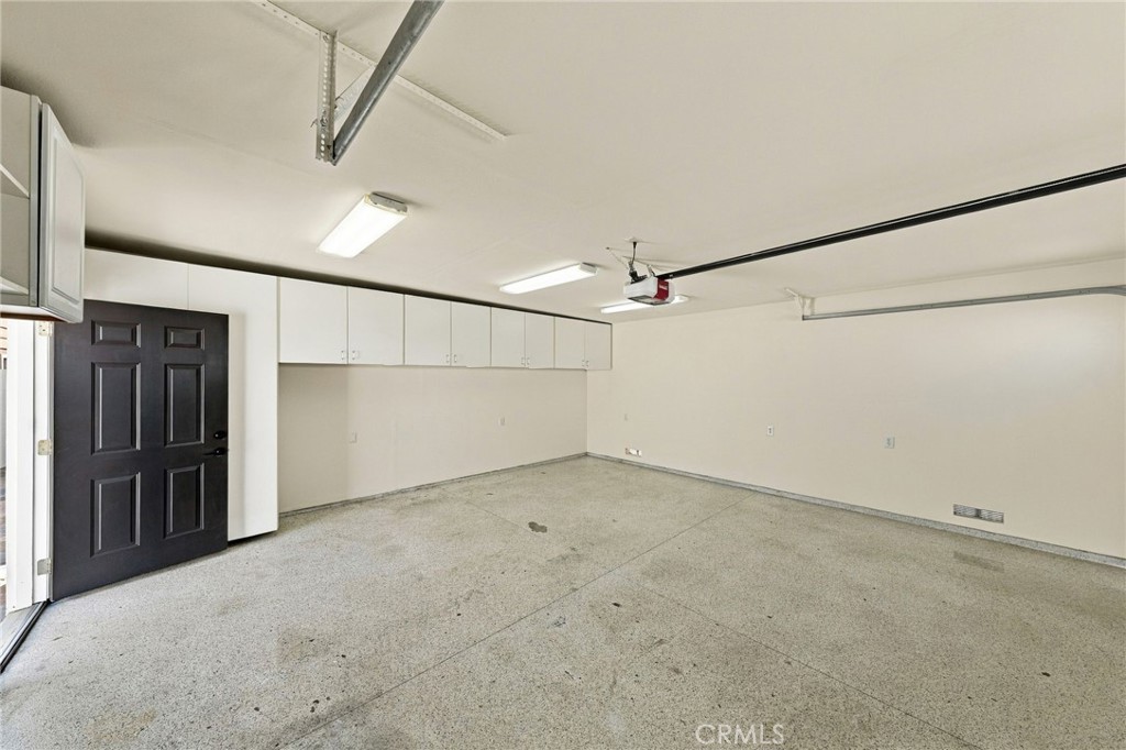 Finished 2-car garage features epoxy flooring and built-in cabinetry for added storage. - 803 Frankfort Avenue, Huntington Beach CA 92648 - photo 63