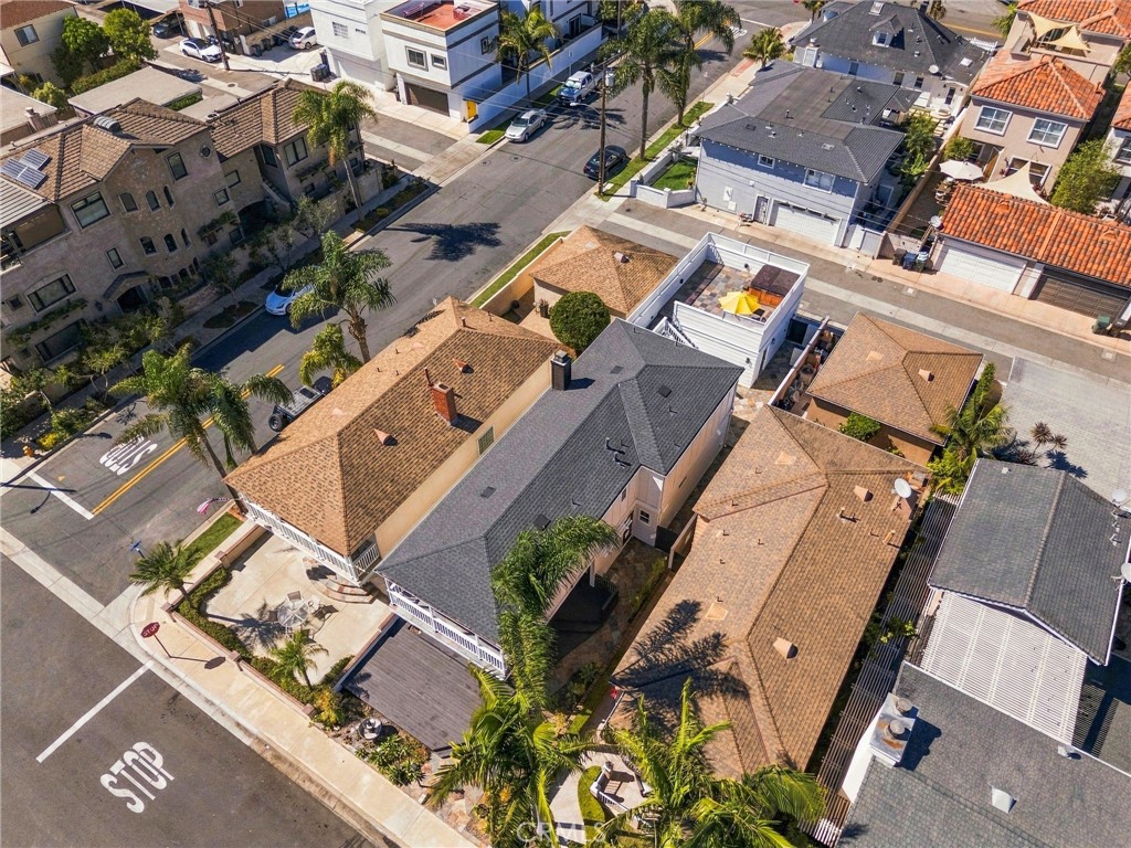 Elevated aerial highlights the residence, detached garage, upper deck, and surrounding neighborhood. - 803 Frankfort Avenue, Huntington Beach CA 92648 - photo 67
