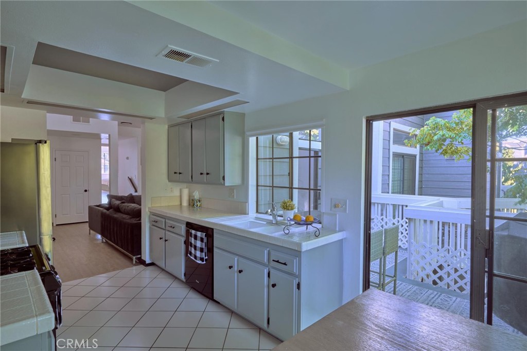 kitchen -facing sliding doors that open to balcony from the breakfast area - 8132 Atwater Circle 202, Huntington Beach CA 92646 - photo 23