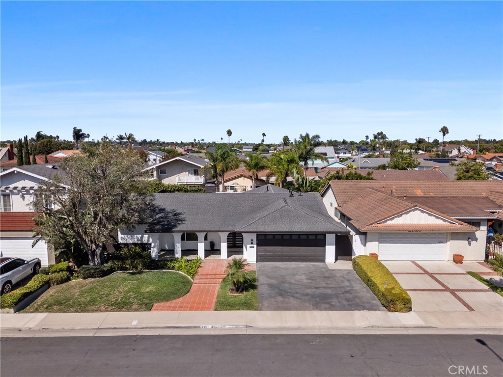 The brick facade and mature trees add warmth and character from the curb. - 8401 Atlanta Avenue, Huntington Beach CA 92646 - photo 1
