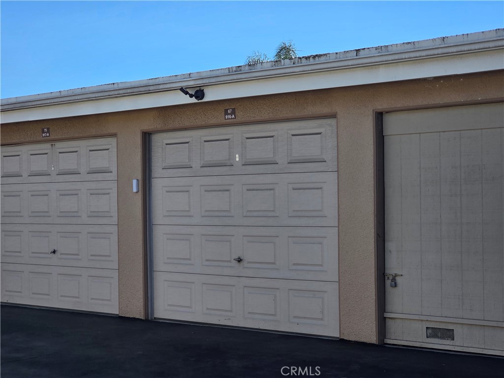 1 Car Garage with roll up door - 8565 Sierra Circle 916A, Huntington Beach CA 92646 - photo 34
