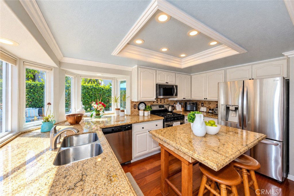 Kitchen with Granite Countertops & Bay Windows. - 8712 Mossford Dr., Huntington Beach CA 92646 - photo 13