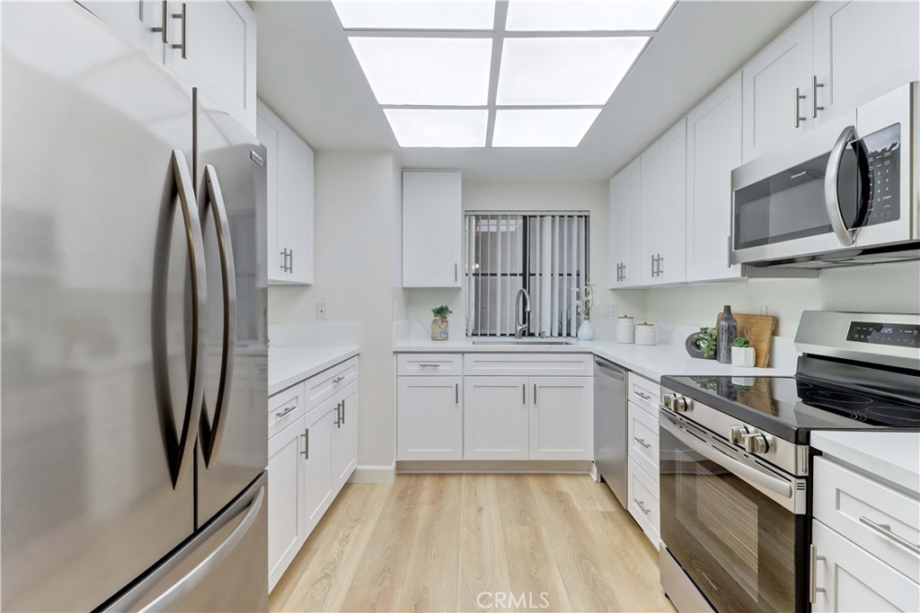 Remodeled Kitchen w/ LED panel lighting that has different Light settings ranging from cool to warm. - 8877 Lauderdale Court 210-G, Huntington Beach CA 92646 - photo 1
