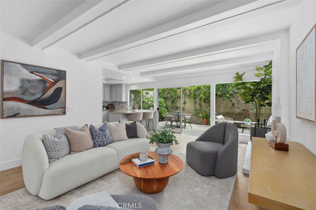 Family room with fireplace, beamed ceilings and wall to wall windows - 9001 Oceanwood Drive, Huntington Beach CA 92646 - photo 1