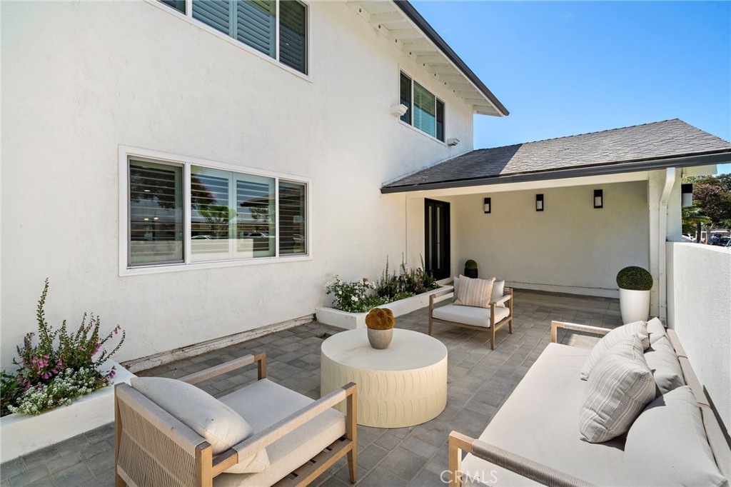 Another view of the inviting front patio, thoughtfully arranged for relaxed outdoor conversation. - 9162 Brabham Drive, Huntington Beach CA 92646 - photo 5