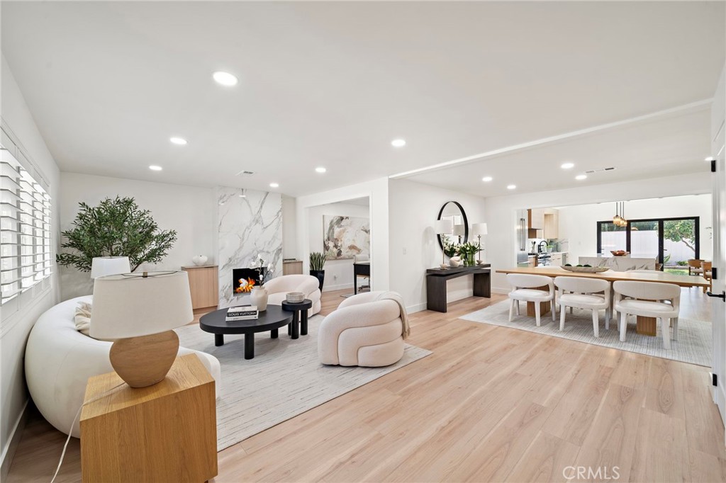 Bright living room features wood-look flooring, recessed lighting and an airy contemporary design. - 9162 Brabham Drive, Huntington Beach CA 92646 - photo 6
