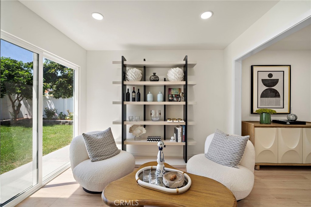Bright sitting room opens through glass doors to the patio and landscaped backyard. - 9162 Brabham Drive, Huntington Beach CA 92646 - photo 20