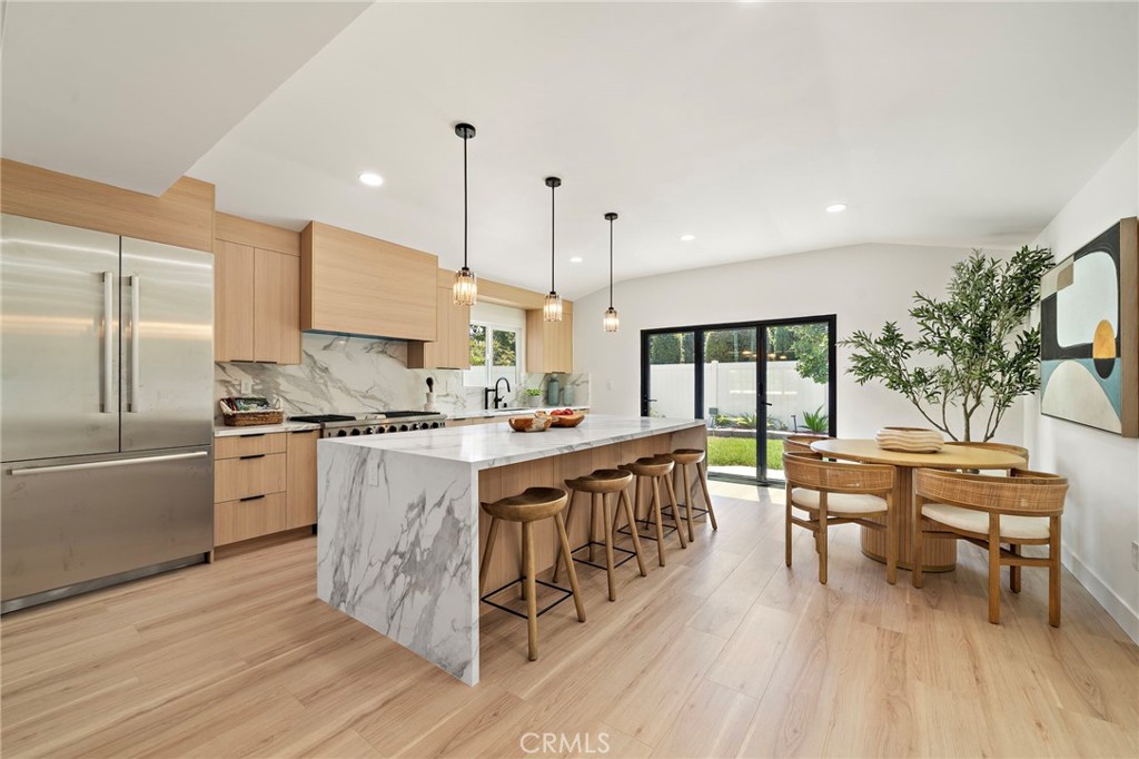 Chef-inspired kitchen features an oversized island, warm natural-wood cabinetry and abundant workspace. - 9162 Brabham Drive, Huntington Beach CA 92646 - photo 21