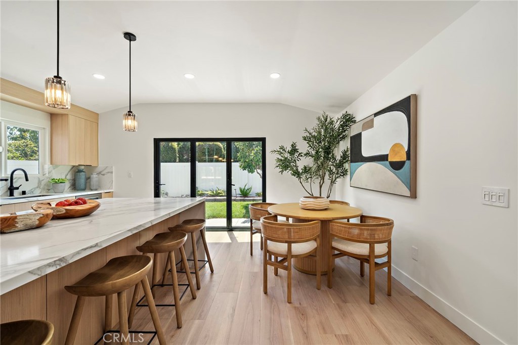 Eat-in kitchen pairs the large center island with a sunny dining area and direct access to the backyard. - 9162 Brabham Drive, Huntington Beach CA 92646 - photo 22