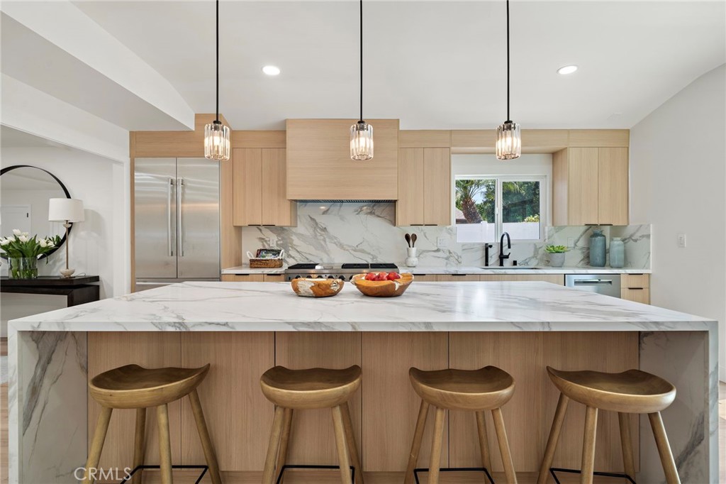 Another view of the open kitchen showcases generous cabinetry, expansive counters and a seamless connection to the dinin - 9162 Brabham Drive, Huntington Beach CA 92646 - photo 23