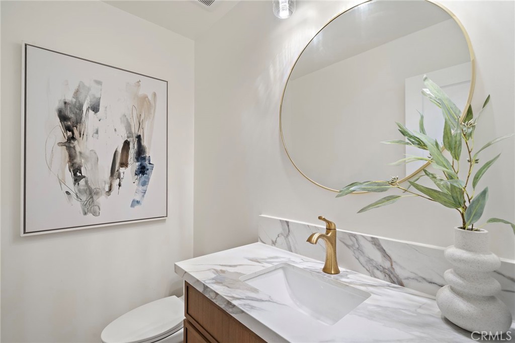 Half of bathroom downstairs soft neutral tones with an elegant finishes - 9162 Brabham Drive, Huntington Beach CA 92646 - photo 29