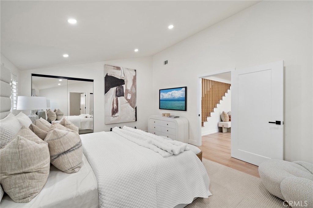 Main-level primary suite connects conveniently to its beautifully renovated private bathroom. - 9162 Brabham Drive, Huntington Beach CA 92646 - photo 32