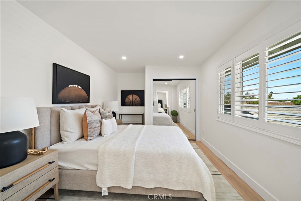 Bright upstairs bedroom features recessed lighting, wood-look flooring and modern window coverings. - 9162 Brabham Drive, Huntington Beach CA 92646 - photo 36