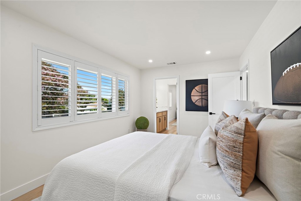 Another view of the upstairs bedroom highlights its comfortable proportions and clean contemporary style. - 9162 Brabham Drive, Huntington Beach CA 92646 - photo 37