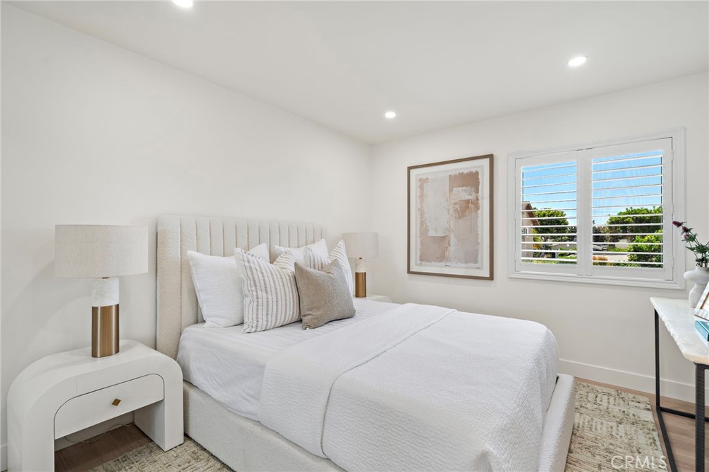 Light-filled secondary bedroom features wood-look flooring, recessed lighting and a fresh contemporary design. - 9162 Brabham Drive, Huntington Beach CA 92646 - photo 42