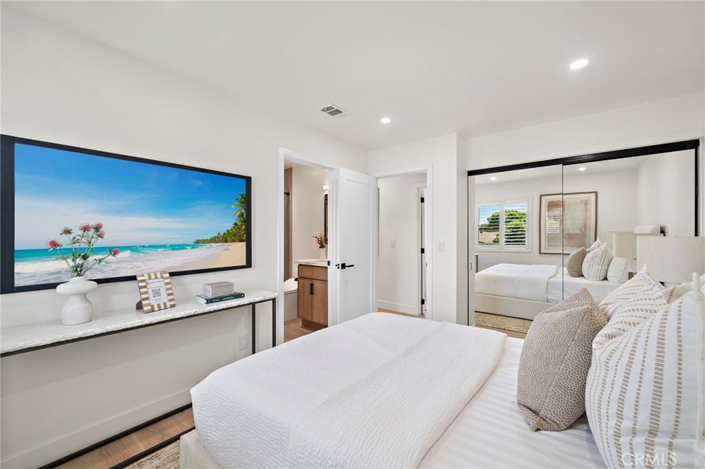 Generously sized upstairs bedroom includes a wall-mounted television and direct access to an adjoining bathroom. - 9162 Brabham Drive, Huntington Beach CA 92646 - photo 43