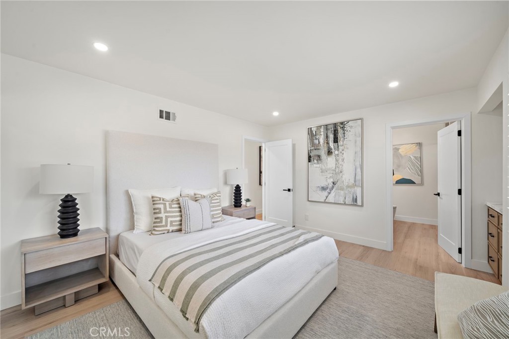 Another bedroom view highlights the home's flexible layout, updated flooring and abundant natural light. - 9162 Brabham Drive, Huntington Beach CA 92646 - photo 46