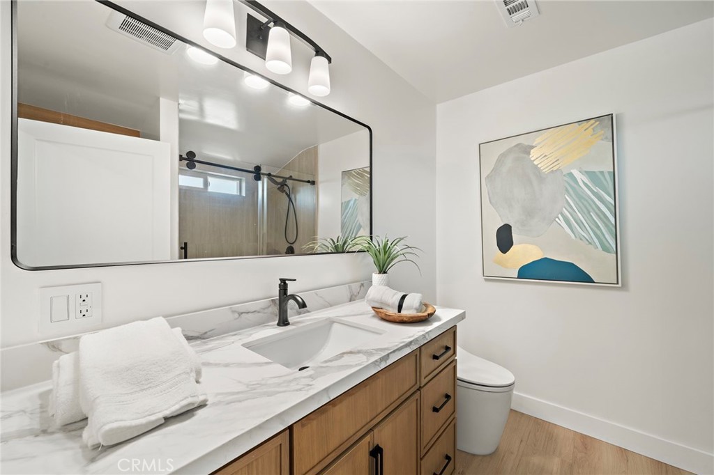 Modern bathroom features a wide vanity, vessel-style sink, designer tile and contemporary fixtures. - 9162 Brabham Drive, Huntington Beach CA 92646 - photo 47