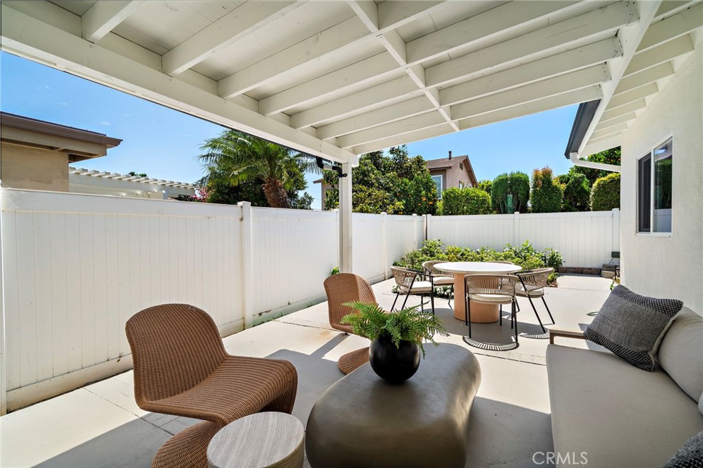 Expansive covered patio creates a comfortable outdoor living and dining area overlooking the backyard. - 9162 Brabham Drive, Huntington Beach CA 92646 - photo 49