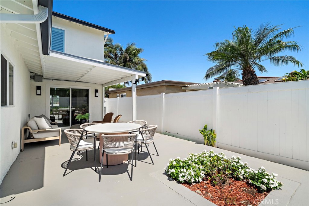 Private patio seating area is surrounded by attractive hardscape and thoughtfully placed landscaping. - 9162 Brabham Drive, Huntington Beach CA 92646 - photo 52