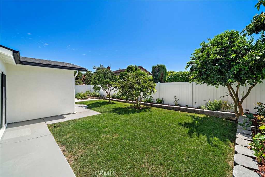 Spacious backyard lawn provides plenty of room for play, pets, gardening or outdoor entertaining. - 9162 Brabham Drive, Huntington Beach CA 92646 - photo 54