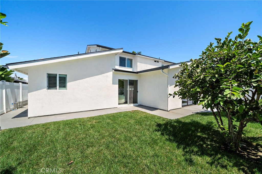 Rear exterior is framed by mature fruit trees, lawn and a private, beautifully landscaped yard. - 9162 Brabham Drive, Huntington Beach CA 92646 - photo 55