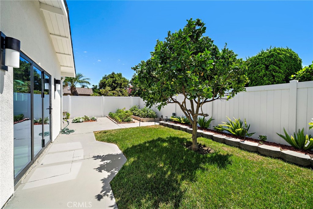Wide backyard view highlights the expansive lawn, patios and generous outdoor living space. - 9162 Brabham Drive, Huntington Beach CA 92646 - photo 56