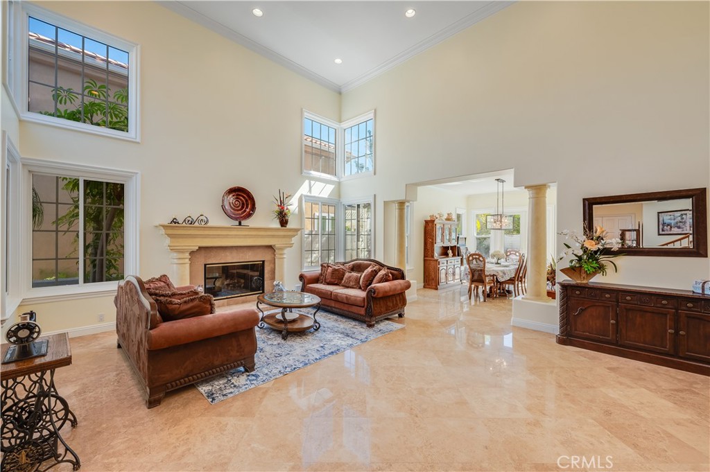 Living Room with Large Gas Fireplace looking into the Formal Dining Room - 9332 Power, Huntington Beach CA 92646 - photo 8