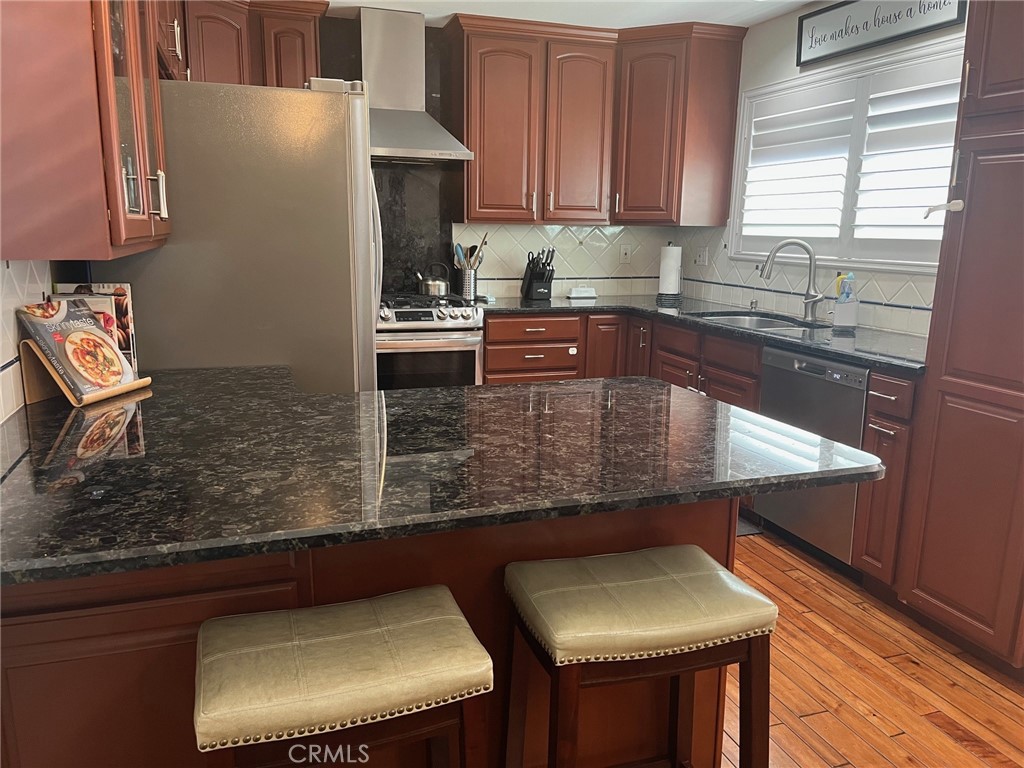 Open Kitchen with Breakfast bar great floor plan for entertaining - 9583 Pettswood Drive 4, Huntington Beach CA 92646 - photo 1
