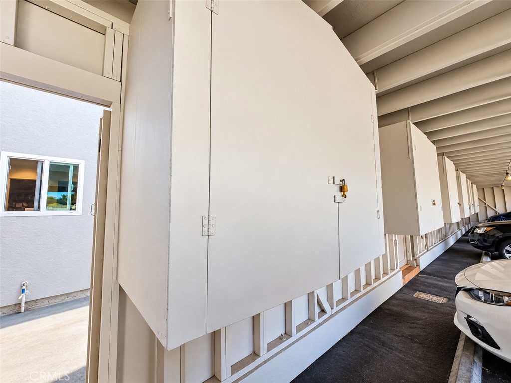 Assigned carport space has storage cabinets and direct access to your home. - 9857 Continental, Huntington Beach CA 92646 - photo 19