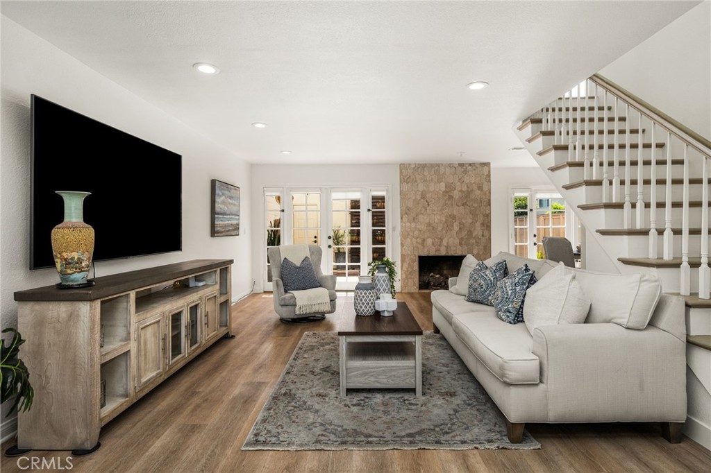 Spacious living room featuring a cozy fireplace. - 9921 Barranca Circle, Huntington Beach CA 92646 - photo 3