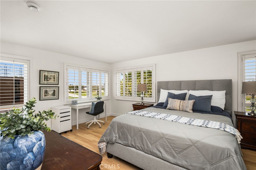 Spacious primary bedroom with beautiful park views. - 9921 Barranca Circle, Huntington Beach CA 92646 - photo 6