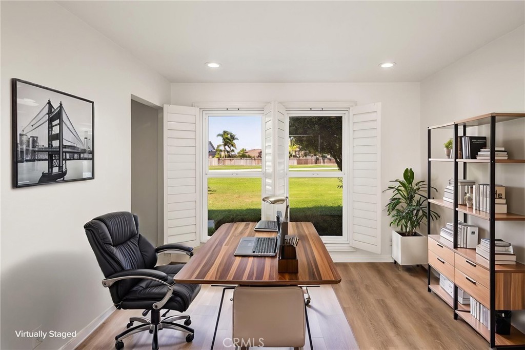 Main-level bedroom virtually staged as a home office. - 9921 Barranca Circle, Huntington Beach CA 92646 - photo 34