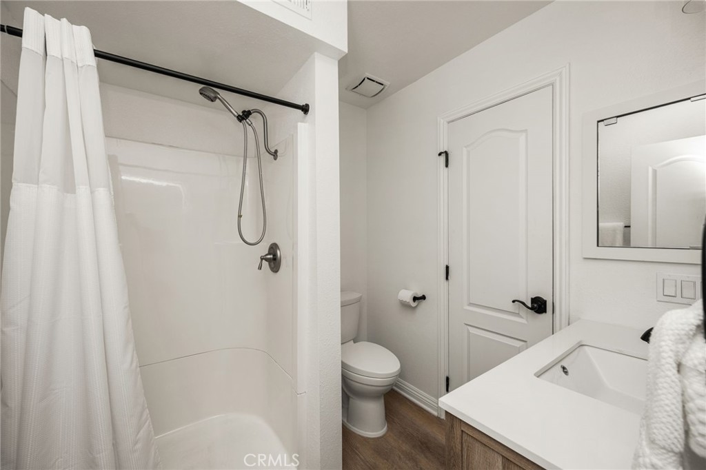 Main-level full bathroom with shower. - 9921 Barranca Circle, Huntington Beach CA 92646 - photo 36