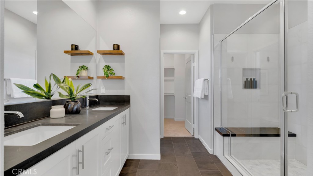 Primary Bath - Dual Sinks with Matte Granite Counters, Marble Shower, and Walk-In Closet - 100 Tenor, Irvine CA 92618 - photo 25