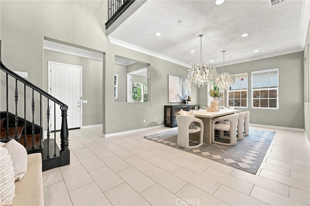 A welcoming entry with soaring ceilings and an elegant staircase sets the tone for the home's thoughtfully designed inte - 104 Sparrow, Irvine CA 92618 - photo 5
