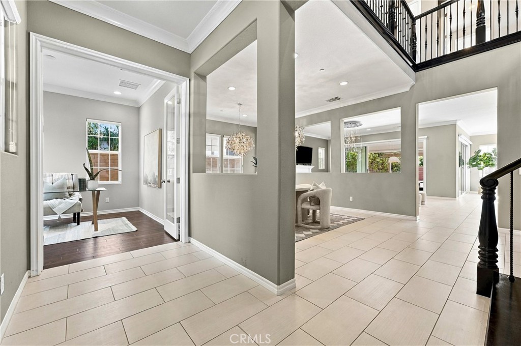 A welcoming entry with soaring ceilings and an elegant staircase sets the tone for the home's thoughtfully designed inte - 104 Sparrow, Irvine CA 92618 - photo 6