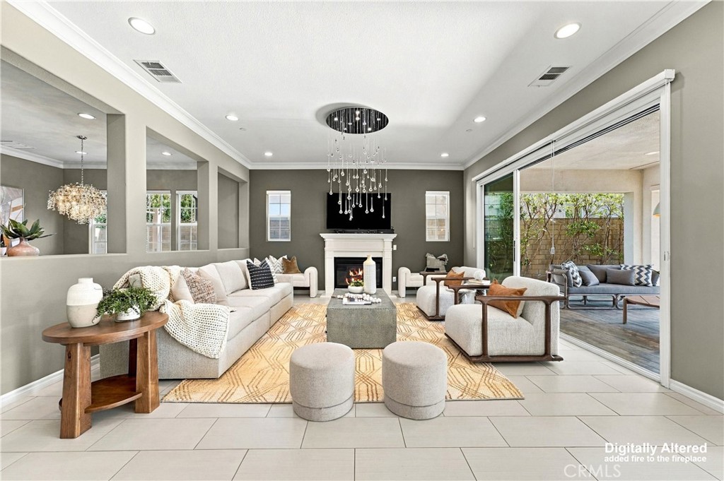 A spacious great room with fireplace, opens to a California room. - 104 Sparrow, Irvine CA 92618 - photo 14