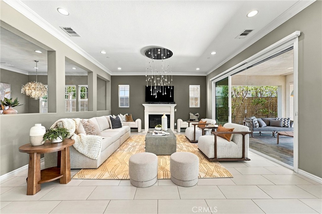 A spacious great room with fireplace, opens to a California room. - 104 Sparrow, Irvine CA 92618 - photo 16