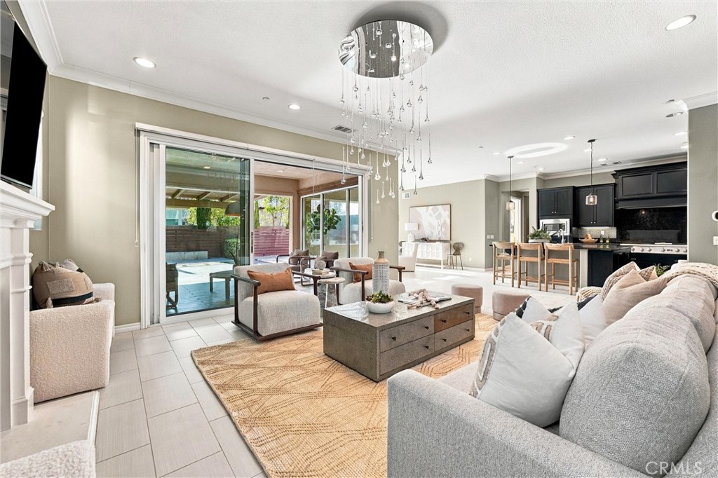 A spacious great room with fireplace, opens to a California room. - 104 Sparrow, Irvine CA 92618 - photo 17